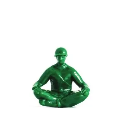 A green toy soldier, meditating.