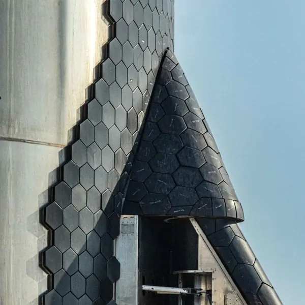 Black heat-shield tiles on a rocket.
